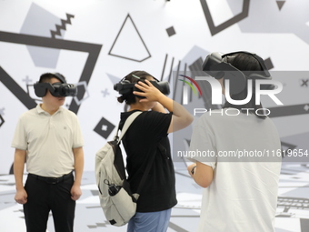 Visitors bring VR devices to experience the Digital Zhongshan Experience Museum in Nanjing, China, on September 29, 2024. (