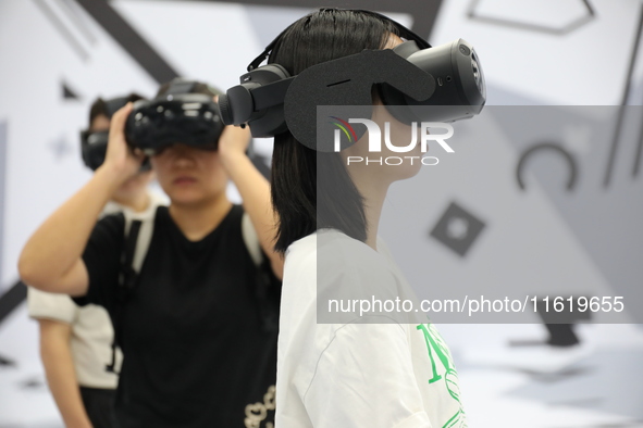 Visitors bring VR devices to experience the Digital Zhongshan Experience Museum in Nanjing, China, on September 29, 2024. 