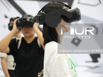 Visitors bring VR devices to experience the Digital Zhongshan Experience Museum in Nanjing, China, on September 29, 2024. (