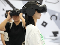 Visitors bring VR devices to experience the Digital Zhongshan Experience Museum in Nanjing, China, on September 29, 2024. (