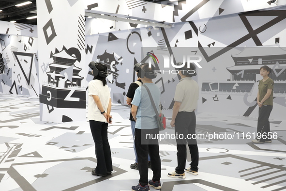 Visitors bring VR devices to experience the Digital Zhongshan Experience Museum in Nanjing, China, on September 29, 2024. 