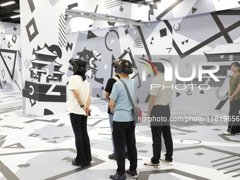 Visitors bring VR devices to experience the Digital Zhongshan Experience Museum in Nanjing, China, on September 29, 2024. (