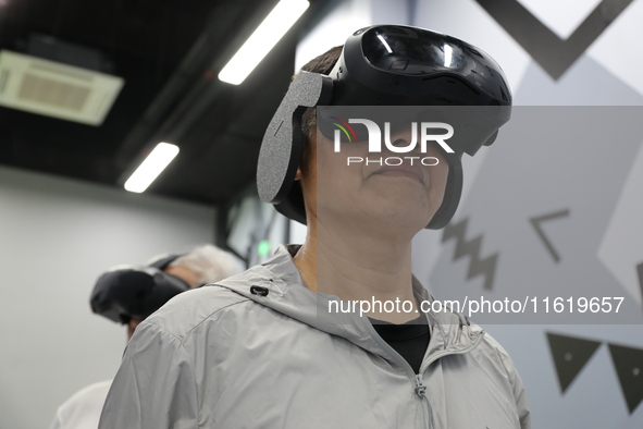 Visitors bring VR devices to experience the Digital Zhongshan Experience Museum in Nanjing, China, on September 29, 2024. 