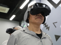 Visitors bring VR devices to experience the Digital Zhongshan Experience Museum in Nanjing, China, on September 29, 2024. (