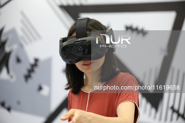 Visitors bring VR devices to experience the Digital Zhongshan Experience Museum in Nanjing, China, on September 29, 2024. 