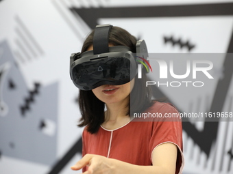 Visitors bring VR devices to experience the Digital Zhongshan Experience Museum in Nanjing, China, on September 29, 2024. (