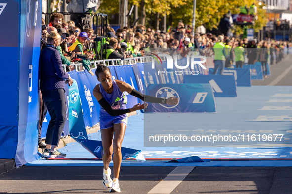 Tigist Ketema of Ethiopia dances after winning the women's race at the 50th Berlin Marathon with a time of 2:16:40, followed by compatriots...