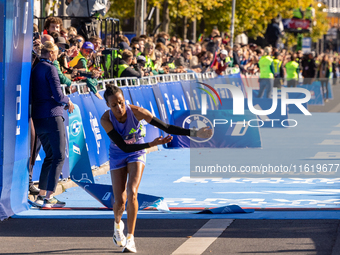 Tigist Ketema of Ethiopia dances after winning the women's race at the 50th Berlin Marathon with a time of 2:16:40, followed by compatriots...