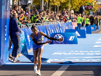 Tigist Ketema of Ethiopia dances after winning the women's race at the 50th Berlin Marathon with a time of 2:16:40, followed by compatriots...