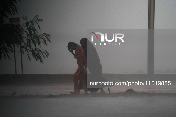 Women walk amid the heavy rains in Colombo, Sri Lanka, on September 29, 2024. 