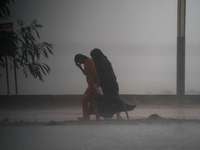 Women walk amid the heavy rains in Colombo, Sri Lanka, on September 29, 2024. (