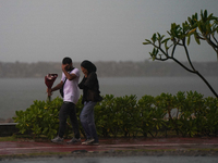 A couple walks amid the heavy rains in Colombo, Sri Lanka, on September 29, 2024. (