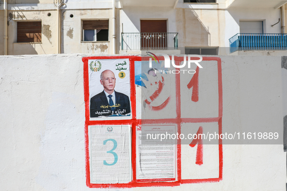 An election poster of the presidential candidate Kais Saied is pasted on a wall along a street in Ariana, Tunisia, on September 29, 2024, du...