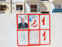 An election poster of the presidential candidate Kais Saied is pasted on a wall along a street in Ariana, Tunisia, on September 29, 2024, du...