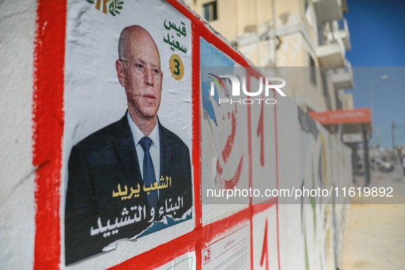 An election poster of the presidential candidate Kais Saied is pasted on a wall along a street in Ariana, Tunisia, on September 29, 2024, du...