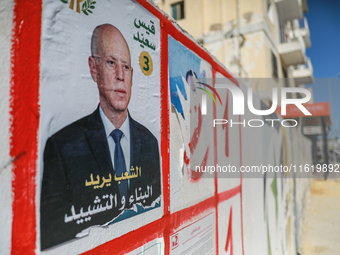 An election poster of the presidential candidate Kais Saied is pasted on a wall along a street in Ariana, Tunisia, on September 29, 2024, du...