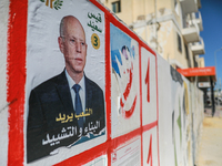 An election poster of the presidential candidate Kais Saied is pasted on a wall along a street in Ariana, Tunisia, on September 29, 2024, du...