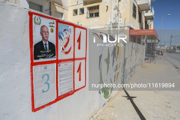 An election poster of the presidential candidate Kais Saied is pasted on a wall along a street in Ariana, Tunisia, on September 29, 2024, du...