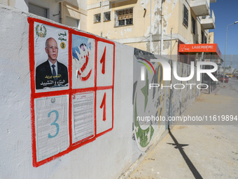 An election poster of the presidential candidate Kais Saied is pasted on a wall along a street in Ariana, Tunisia, on September 29, 2024, du...