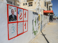 An election poster of the presidential candidate Kais Saied is pasted on a wall along a street in Ariana, Tunisia, on September 29, 2024, du...