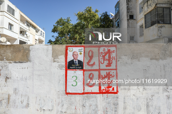 An election poster of the presidential candidate Kais Saied is pasted on a wall along a street in Ariana, Tunisia, on September 29, 2024, du...