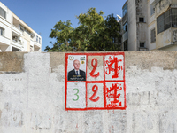 An election poster of the presidential candidate Kais Saied is pasted on a wall along a street in Ariana, Tunisia, on September 29, 2024, du...