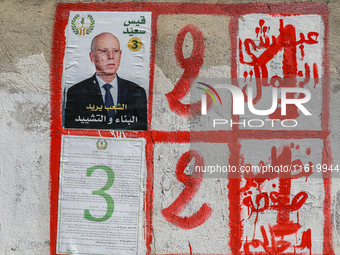 An election poster of the presidential candidate Kais Saied is pasted on a wall along a street in Ariana, Tunisia, on September 29, 2024, du...