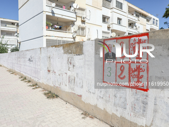 An election poster of the presidential candidate Kais Saied is pasted on a wall along a street in Ariana, Tunisia, on September 29, 2024, du...