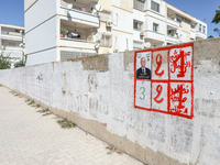 An election poster of the presidential candidate Kais Saied is pasted on a wall along a street in Ariana, Tunisia, on September 29, 2024, du...