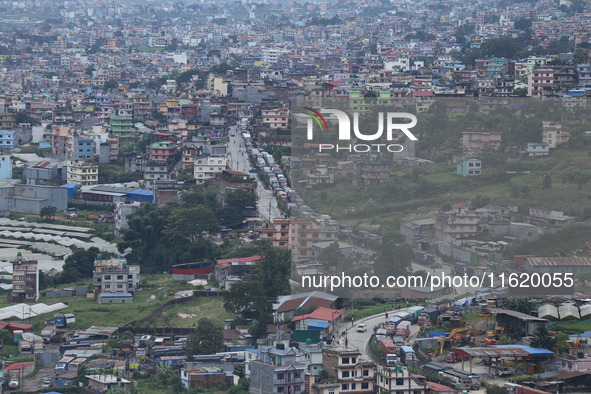 Stranded vehicles are pictured from Jhyaple Khola in Dhading District of Central Nepal after a landslide disrupts vehicular movement along t...