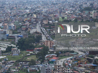 Stranded vehicles are pictured from Jhyaple Khola in Dhading District of Central Nepal after a landslide disrupts vehicular movement along t...