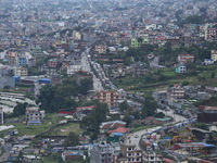 Stranded vehicles are pictured from Jhyaple Khola in Dhading District of Central Nepal after a landslide disrupts vehicular movement along t...