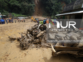 Debris of passenger vehicles excavated by Nepali security personnel while searching for missing passengers lies on the site of a landslide i...