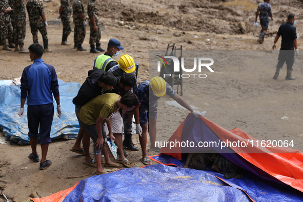 A relative of a Nepali passenger who is buried in the landslide in Jhyaple Khola of Dhading District of Central Nepal undergoes the process...