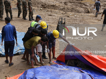 A relative of a Nepali passenger who is buried in the landslide in Jhyaple Khola of Dhading District of Central Nepal undergoes the process...