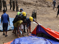 A relative of a Nepali passenger who is buried in the landslide in Jhyaple Khola of Dhading District of Central Nepal undergoes the process...