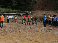 Nepal Army personnel carry the body of a passenger retrieved from the landslide site in Jhyaple Khola in Dhading district of Central Nepal o...