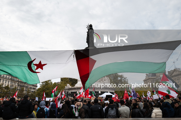 Protesters attend a demonstration in support of Lebanese people as intense Israeli attacks across Lebanon's east, south, and southern Beirut...