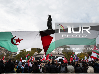 Protesters attend a demonstration in support of Lebanese people as intense Israeli attacks across Lebanon's east, south, and southern Beirut...