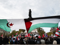 Protesters attend a demonstration in support of Lebanese people as intense Israeli attacks across Lebanon's east, south, and southern Beirut...