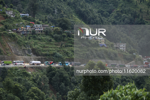 Vehicles stranded along the Tribhuvan Highway are pictured from Jhyaple Khola in Dhading District of Central Nepal on September 29, 2024. At...