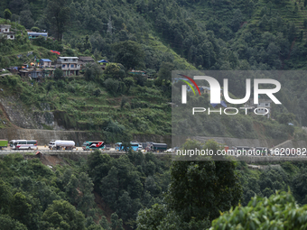 Vehicles stranded along the Tribhuvan Highway are pictured from Jhyaple Khola in Dhading District of Central Nepal on September 29, 2024. At...