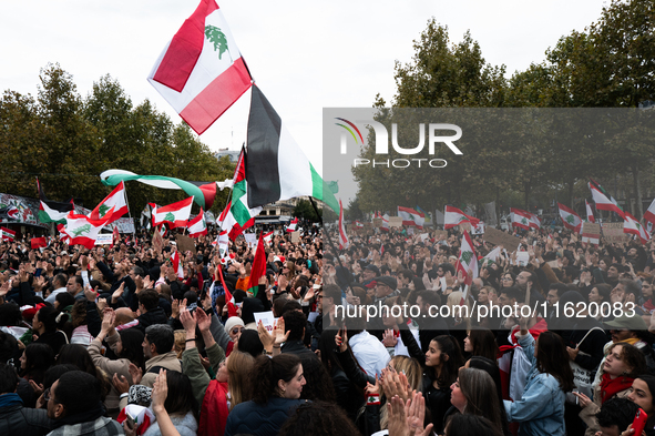 Protesters attend a demonstration in support of Lebanese people as intense Israeli attacks across Lebanon's east, south, and southern Beirut...