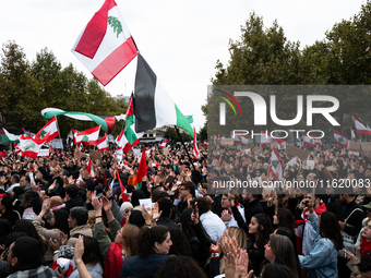 Protesters attend a demonstration in support of Lebanese people as intense Israeli attacks across Lebanon's east, south, and southern Beirut...