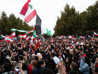 Protesters attend a demonstration in support of Lebanese people as intense Israeli attacks across Lebanon's east, south, and southern Beirut...