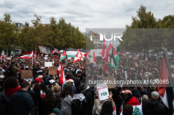 Protesters attend a demonstration in support of Lebanese people as intense Israeli attacks across Lebanon's east, south, and southern Beirut...