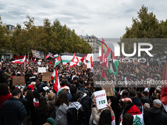 Protesters attend a demonstration in support of Lebanese people as intense Israeli attacks across Lebanon's east, south, and southern Beirut...