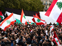 Protesters wave Lebanese flags during a demonstration in support of Lebanese people as intense Israeli attacks across Lebanon's east, south,...