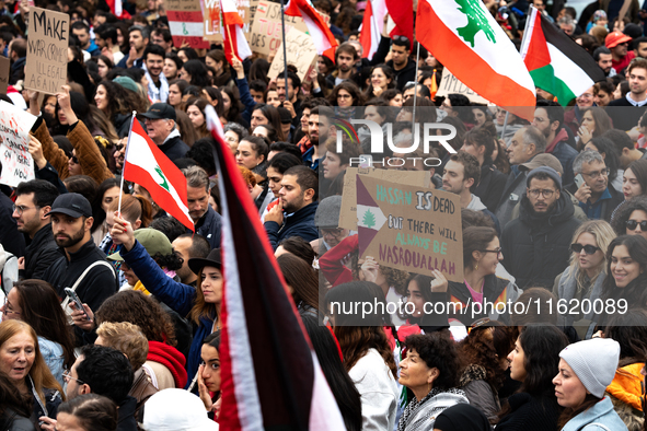 Protesters attend a demonstration in support of Lebanese people as intense Israeli attacks across Lebanon's east, south, and southern Beirut...