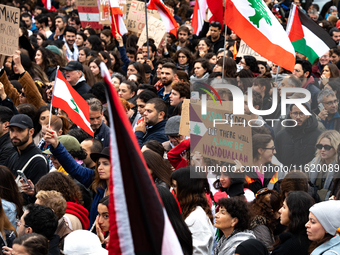 Protesters attend a demonstration in support of Lebanese people as intense Israeli attacks across Lebanon's east, south, and southern Beirut...